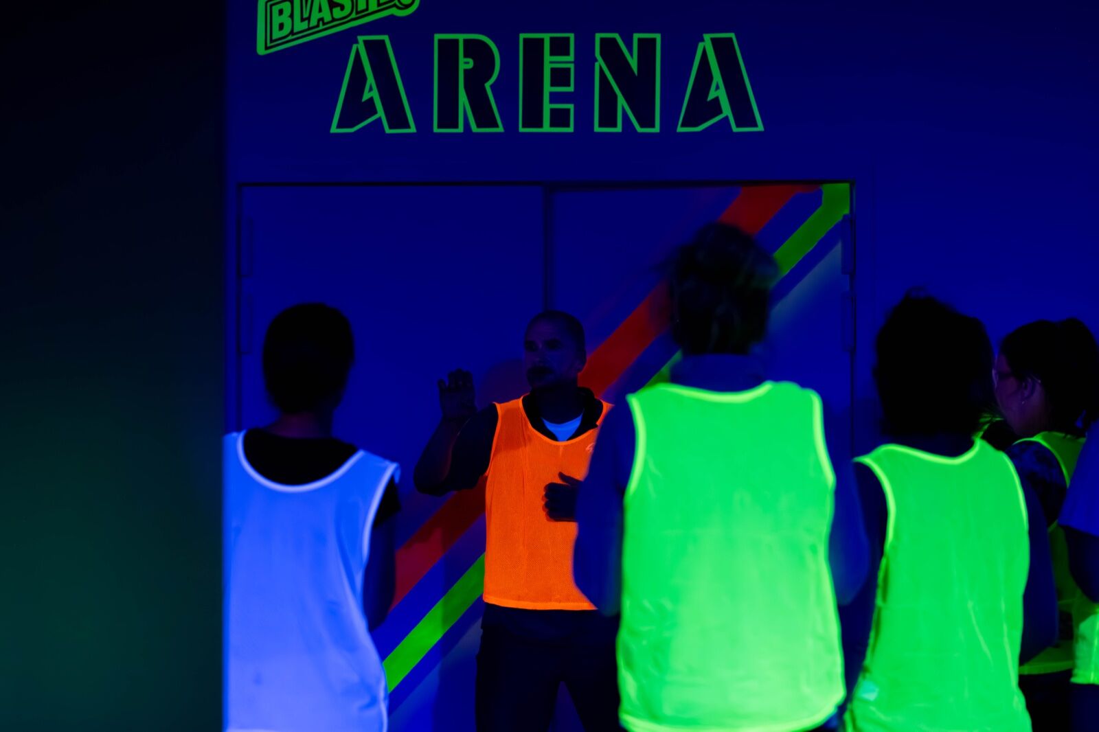 A Game Marshall walking players in neon jerseys through the game plan before the first round